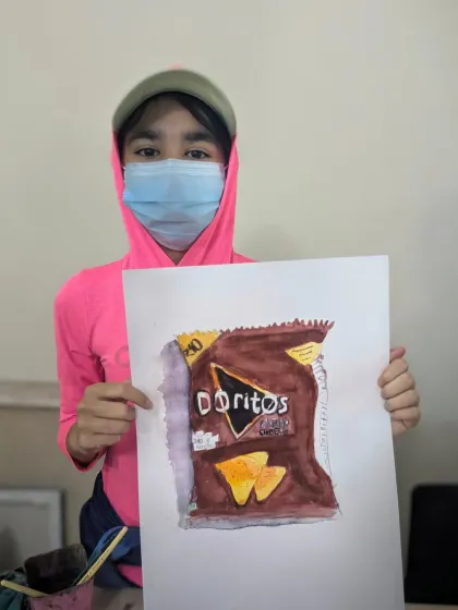 Turning an everyday object into art. Ariya, age 11, did a fantastic job with this realistic watercolor painting of a Doritos bag for her object study class.