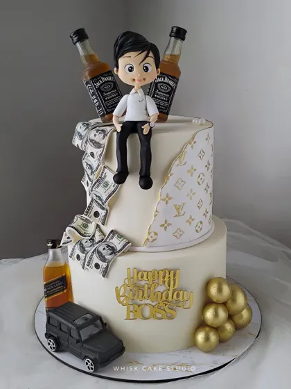 A grand cake for the boss. This two-tiered cake features a personalized figurine, edible money, miniature liquor bottles, and a luxury car model.