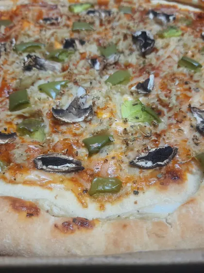 A classic veggie pizza with a thick, satisfying stuffed crust, topped with mushrooms, capsicum, and melted vegan cheese.