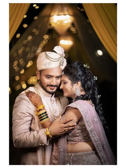 A romantic embrace under the warm glow of reception lights. This candid photo captures the beautiful connection between the newlyweds.