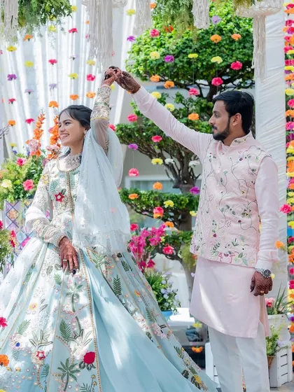 A beautiful shot of the couple dancing, showcasing the bride's stunning floral lehenga that perfectly matches the carnival theme.
