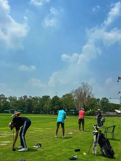 A clear blue sky over the driving range on a perfect day for golf.