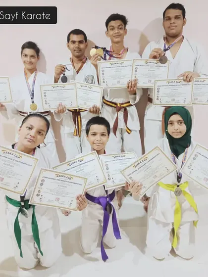 Our team of karateka winners from the Open Karate Championship. Seeing students of all belt levels, from green and yellow to brown, standing together with their awards is the best reward for an instructor.