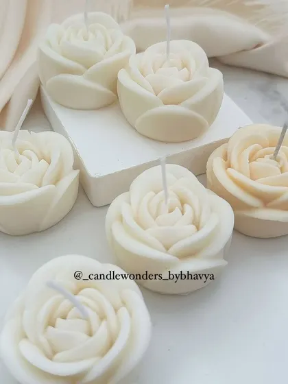 A set of six handmade rose-scented candles, a simple and classic gift.