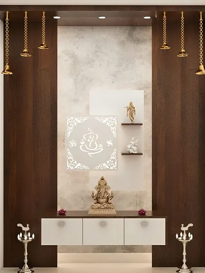 A modern pooja unit with a backlit Ganesha jali panel. The floating white console and hanging temple bells create a light and airy feel.