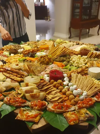 Our XXXL platter fills the table with crackers, vegetables, dips and little bites, with the finishing touches still going on.