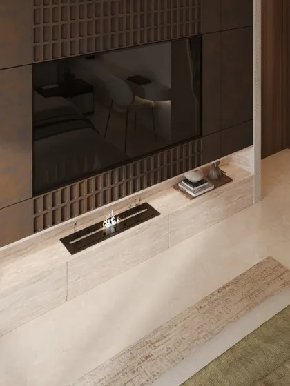 The TV wall opposite the bed features intricate, dark wood paneling with a grid-like texture, adding depth and a sense of craftsmanship. A small, modern fireplace is integrated below.