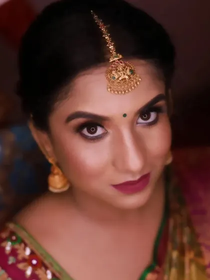 A close-up portrait of Rachana. Her eyes are the focus here, with sharp liner and well-defined brows framing her expressive look.