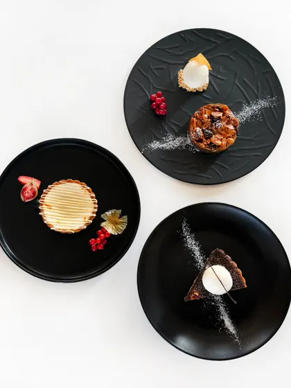 A trio of our reimagined Indian mithai. Here you see our warm doda burfi treacle tart, badam halwa pie, and besan ladoo tart, each a modern take on a festive classic.