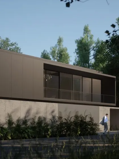 This residence in Hyderabad uses a minimalist palette of concrete and dark metal panels. The building is nestled into the landscape, with the lower level partially submerged in the earth, creating a strong connection to the site.