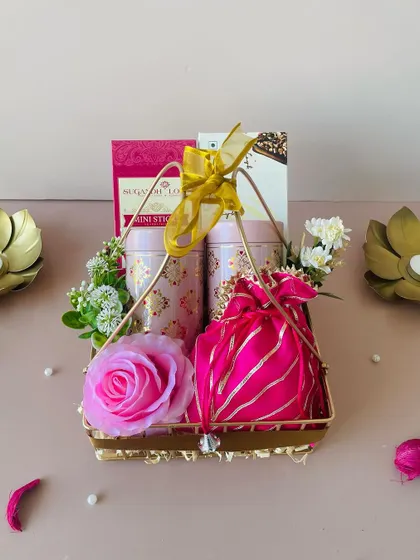 Another view of our gold metal basket hamper, showing the intricate metalwork and the beautiful contrast of pink and gold.