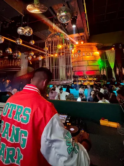 A shot from behind the decks at Toy Boy, showing the packed floor and unique ambiance of the club.