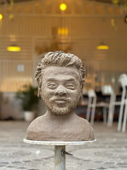 Another view of the sculpted bust, showing the incredible likeness and the texture of the raw clay.