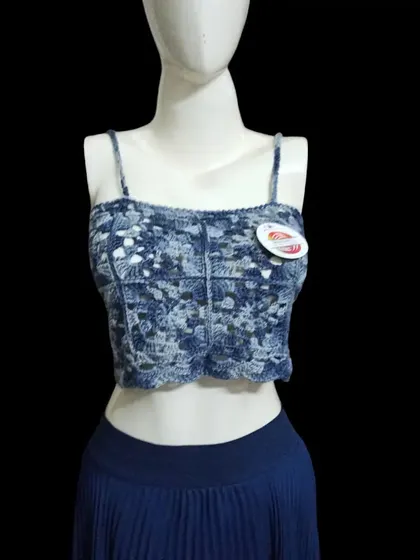 A closer look at the blue variegated yarn crop top. You can see the detailed stitch work and how the colors blend together to create a unique, almost tie-dye effect.