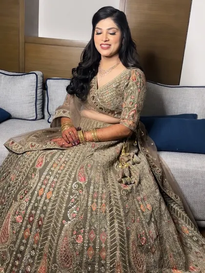 The soft glam makeup allows the intricate details of her gold lehenga to take center stage, creating a perfectly balanced and stunning look.
