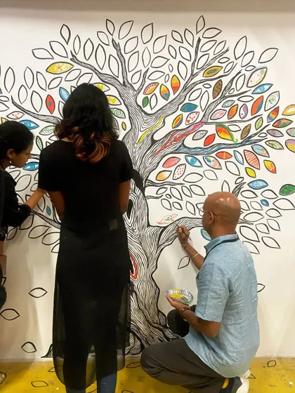 People of all ages and backgrounds coming together to add color to our interactive mural. Each person's contribution makes the final piece richer.