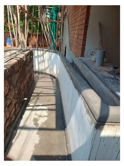 A detail of the construction process, showing the concrete and stone work for the entrance ramp and planters. Every element is carefully considered to contribute to the overall design.
