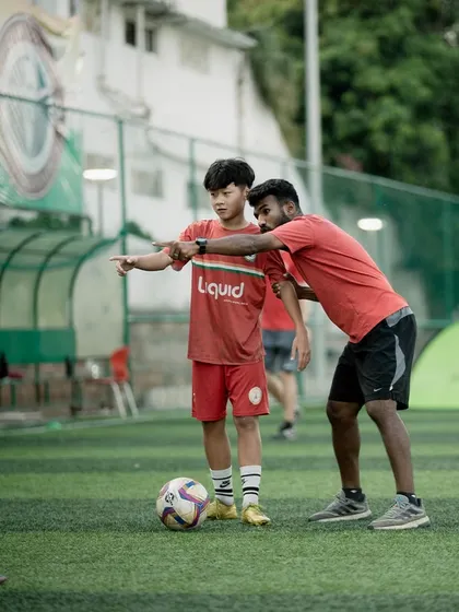A Sudeva coach works closely with a young player, reinforcing the lessons from the VfB Stuttgart team. Our local coaches collaborate to ensure continuity in training.