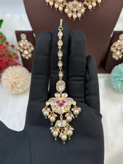 This collection showcases our premium Moissanite Kundan necklaces like the 'Noor Nazaakat' and 'Darbaar' sets. Each comes with a full set of earrings and maang tikka, available in various color combinations.