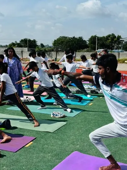 A close-up of students engaged in a warrior pose, building strength, stability, and concentration during our International Yoga Day celebration.