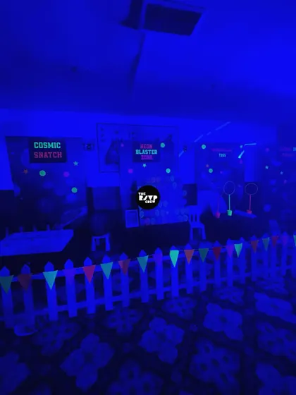I created several cosmic game zones for this space party, including 'Cosmic Snatch' and 'Neon Blaster Zone', all under the glow of blacklights.