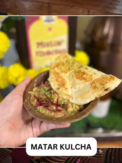 A serving of classic Matar Kulcha, featuring a flavorful white pea curry served with soft, fluffy bread. It's a beloved street food dish that we bring to your celebration.