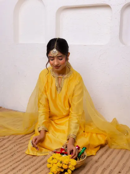 A festive look I styled for A.Projekt, featuring a vibrant yellow salwar suit. The creative direction focused on a clean, minimalist backdrop with pops of yellow flowers to complement the outfit.