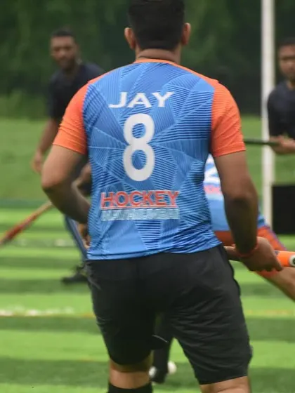 A player wearing the number 8 jersey looks for an opening during a competitive match. Our custom jerseys give our team a strong and unified identity on the field.