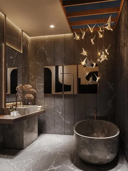I transformed this master bath into a celestial haven. Layered lighting, including a skylight and a sculptural bird-like chandelier, combines with dark, textured stone surfaces to create a truly dramatic and unique bathing experience.