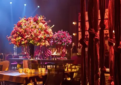 Dramatic red fabric installations and towering floral arrangements added texture and a bold splash of color to the music-focused event.