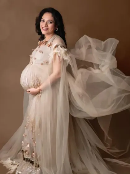 A beautiful portrait of a mom-to-be in our beige embellished gown, with the flowing fabric creating a sense of movement.