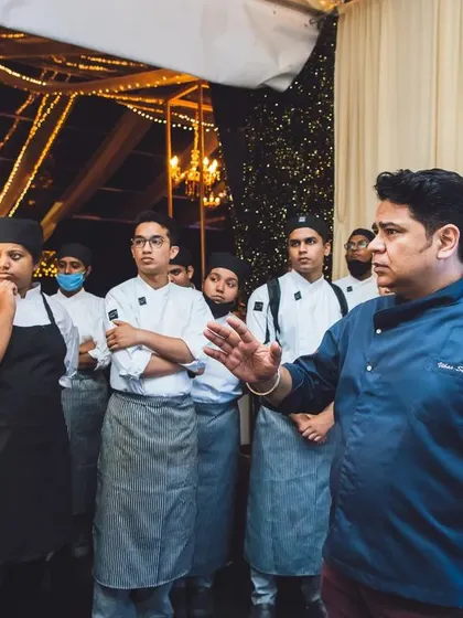 A photo of me giving instructions to my team of young chefs before an event.