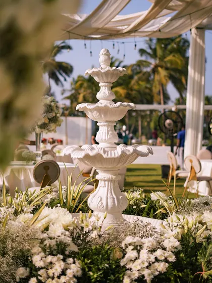 Another view of the fountain, a symbol of life and celebration, perfectly integrated into our floral landscape design for this outdoor wedding.
