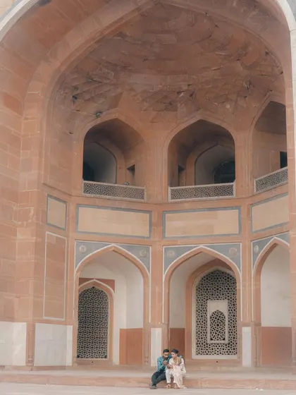 Capturing couples in large, historic spaces allows for a sense of scale and peace. Here, they are framed by the grand arches, making them the focal point in a vast, beautiful setting.
