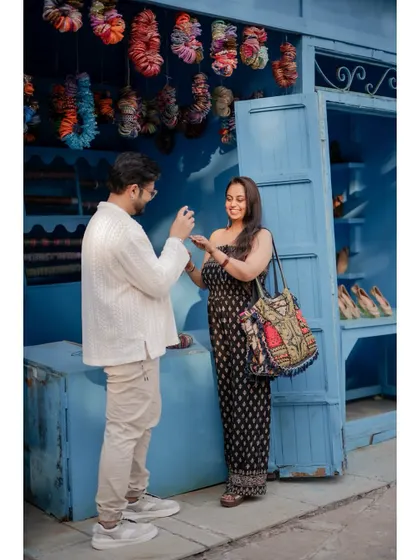 A candid moment of the couple shopping for bangles at a colorful market stall, adding a cultural and vibrant touch to their pre-wedding story.