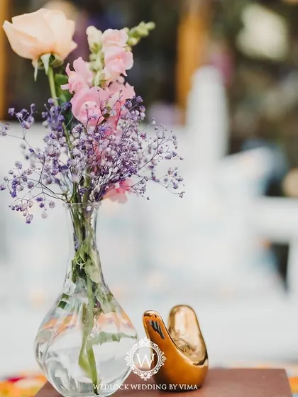 A closer look at the details from a pastel Mehendi. We used delicate floral arrangements, custom welcome signs, and sheer curtains with tiny flowers to create a soft and romantic atmosphere.