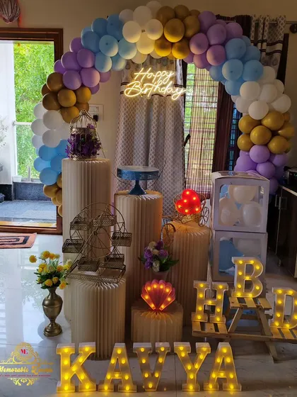A pastel-colored balloon arch with a neon sign and marquee letters, showing a basic but beautiful design option.