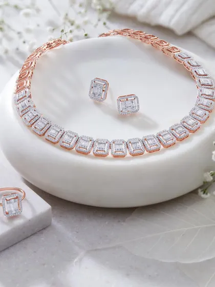This shot showcases a full set of Orra jewelry, including a necklace, ring, and earrings. The clean, white props and delicate flowers create a soft and elegant setting that lets the diamonds take center stage.