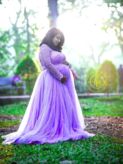 The mother-to-be cradling her bump in a beautiful lavender gown I provided for the shoot. The delicate pearl work on the sleeves adds a touch of elegance.