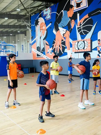 Our youngest players learning the basics of movement and coordination in front of our inspiring mural.