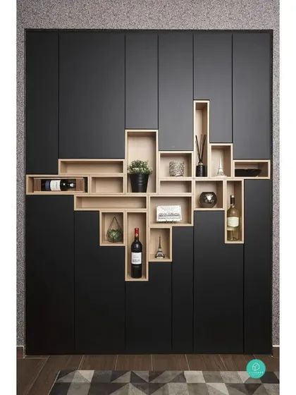 A creative and unique storage solution. This custom-built unit combines a closed wardrobe with open, box-like shelves, creating a functional piece of art that's perfect for displaying wine, books, and decor.