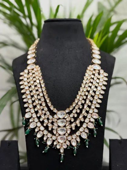 A magnificent multi-layered Polki rani haar with subtle green bead drops at the bottom, perfect for layering over a choker.
