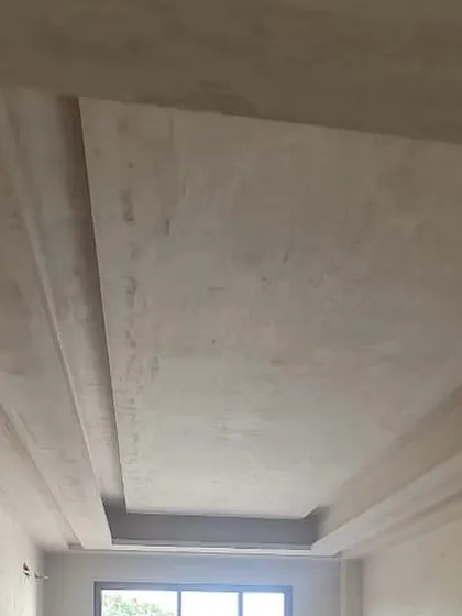 The on-site, work-in-progress photo of the same tray ceiling, showing the design taking shape.