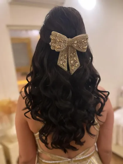 Another angle of this stunning bow hairstyle. It's a perfect choice for a bride or guest who wants to make a bold and stylish statement.