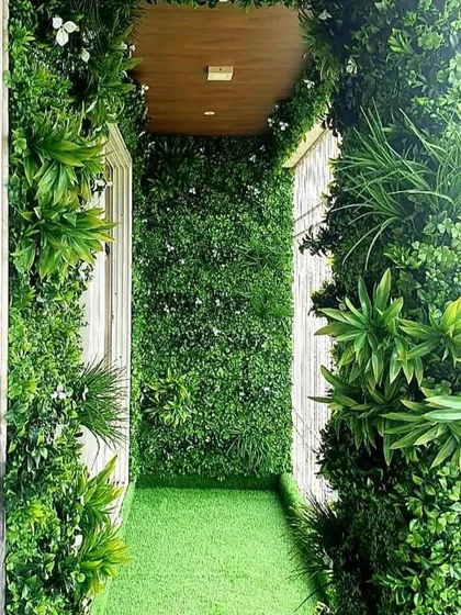 Even the narrowest of balconies can become a lush escape. For this client, we covered the floor, walls, and even the ceiling entrance with a combination of artificial turf and vertical garden panels for a fully immersive green experience.