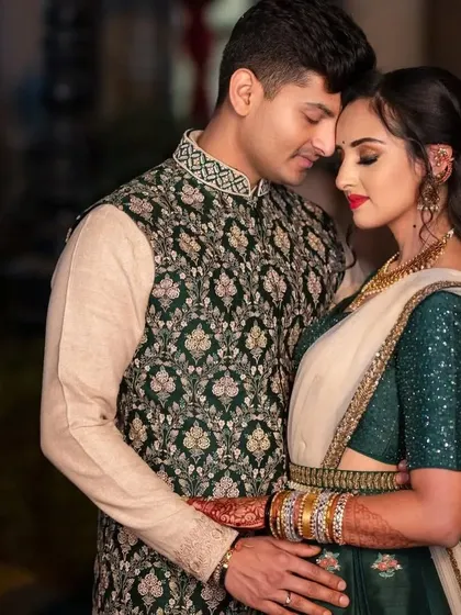 A pre-wedding look that is both traditional and modern. The bride's green lehenga is paired with a classic red lip and soft, glowing skin.