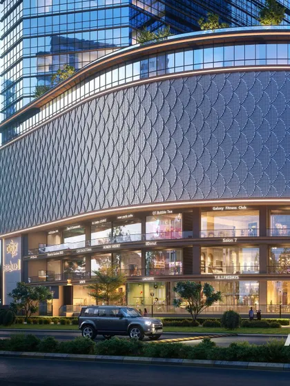 The retail podium of Nakshatra Regalia II. The design features a distinctive patterned facade and multiple levels of high-end retail spaces, creating a vibrant commercial hub at the base of the towers.