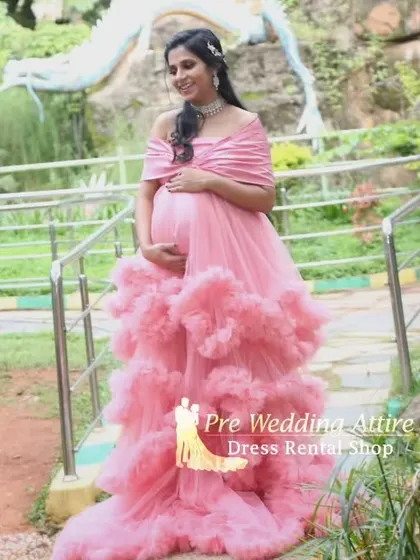 The tiered ruffles on this pink gown create a beautiful cascading effect. It's an ideal rental for an elegant outdoor maternity shoot, providing texture and movement in every shot.