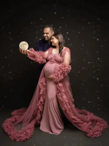 I believe in creating magic. For this celestial-themed maternity portrait, we brought the moon down from the stars to celebrate the universe of love this couple is creating. It’s a blend of fantasy and the very real joy of expecting.