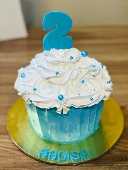 A blue giant cupcake cake for a 2nd birthday.